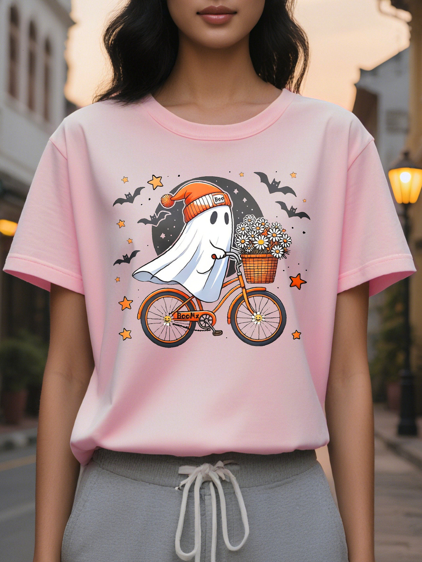 Women Graphic Tee Cute Ghost Riding Bike with Floral Basket Black Orange Design Casual Round Neck T-Shirt for