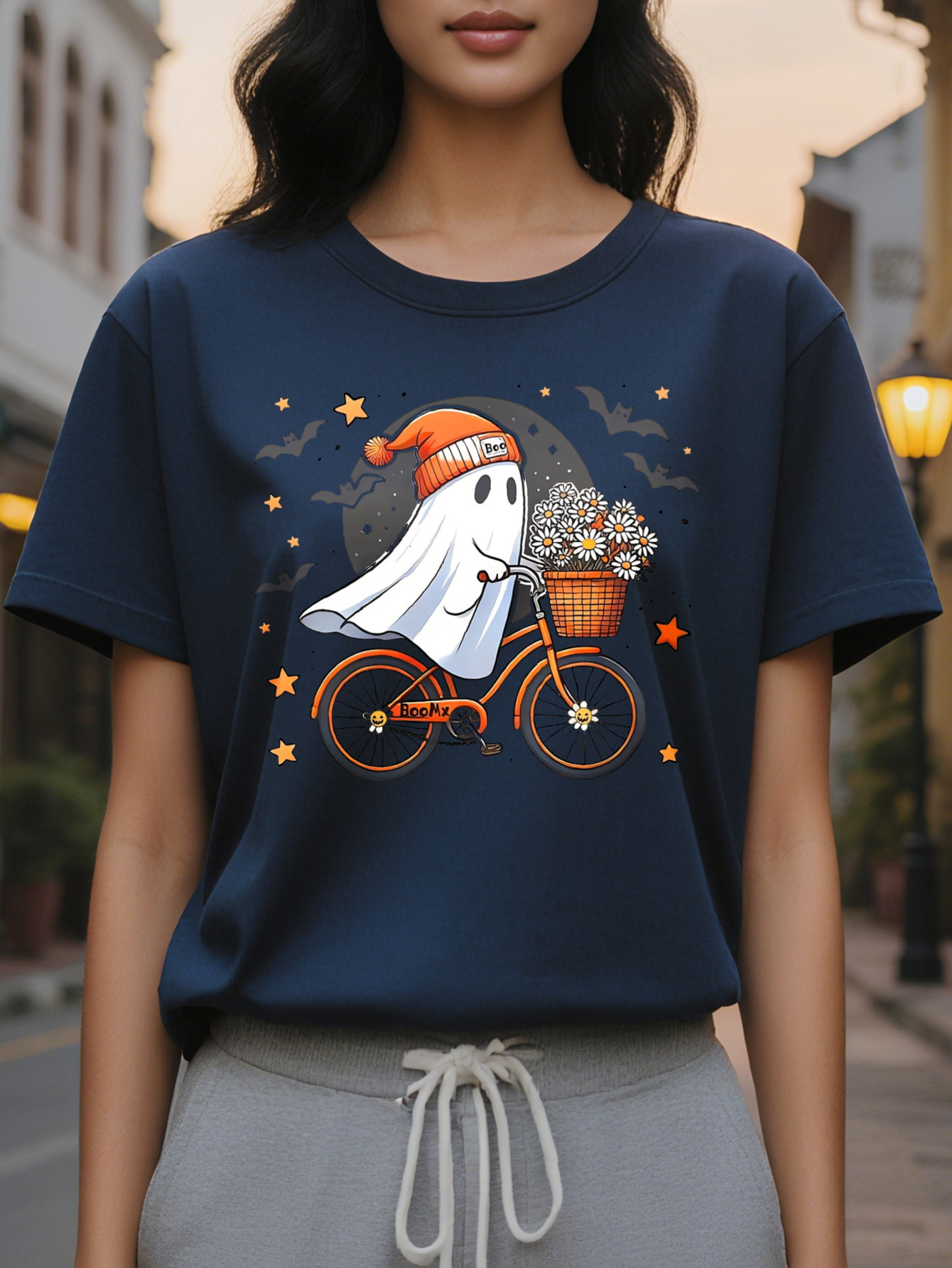 Women Graphic Tee Cute Ghost Riding Bike with Floral Basket Black Orange Design Casual Round Neck T-Shirt for