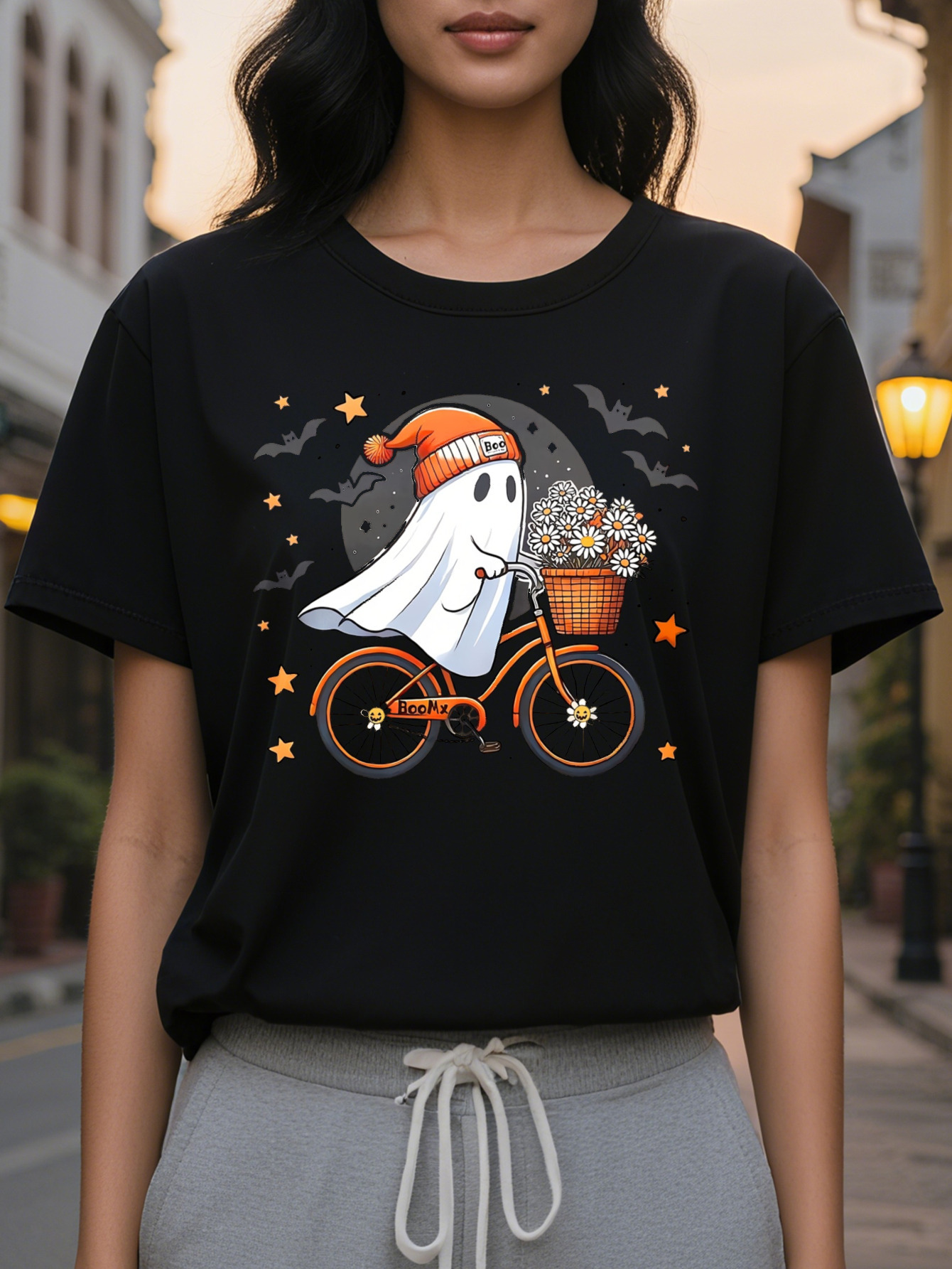 Women Graphic Tee Cute Ghost Riding Bike with Floral Basket Black Orange Design Casual Round Neck T-Shirt for
