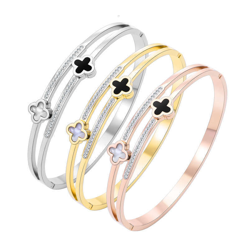 DH collections Korean - style Luxury - inspired Stainless Steel Bracelet. This bracelet with black - and - white four - leaf clover designs is fade - 