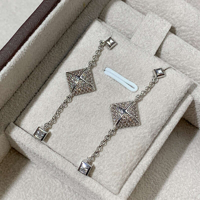 DHcollections Stylish V - Gold Women's Cross - Square Rivet Pendant Chain Earrings with Tassels. These V - Gold earrings feature a unique geometr