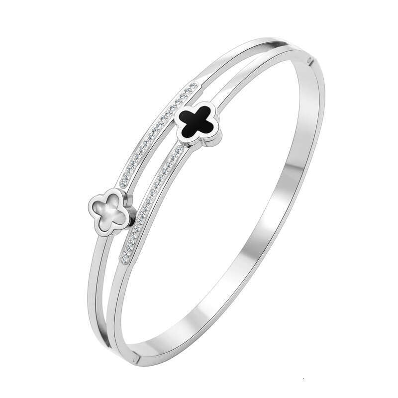 DH collections Korean - style Luxury - inspired Stainless Steel Bracelet. This bracelet with black - and - white four - leaf clover designs is fade - 