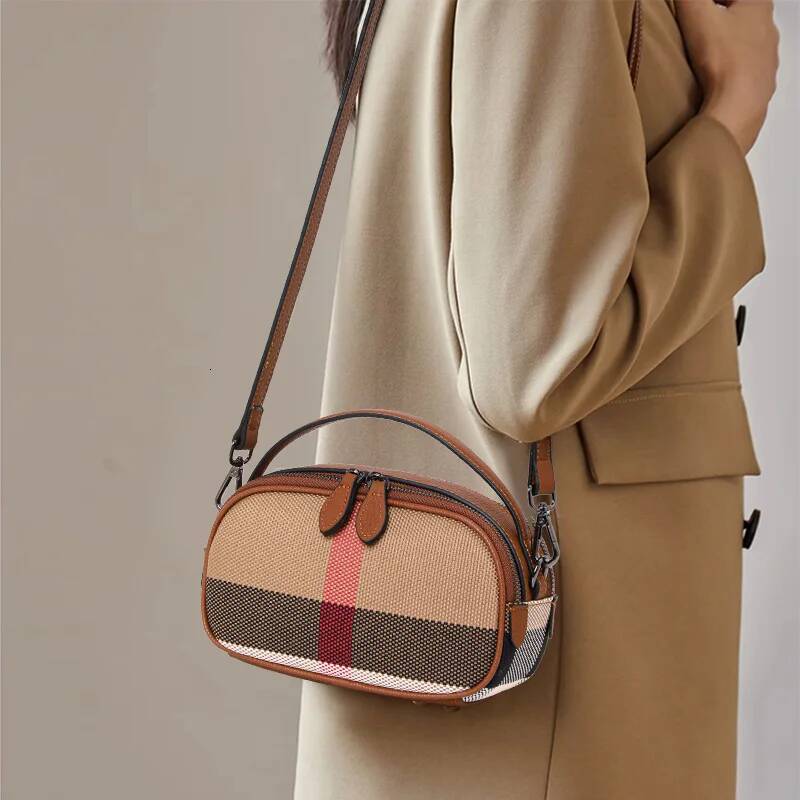 Crafted from canvas cowhide material, Aidrani's brown checkered round women's single shoulder crossbody bag