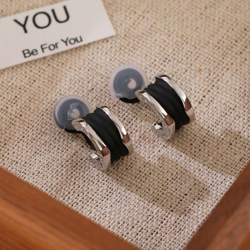 DH collections New Arrival! Women's Stylish Black Tweed - inspired Ear Clips & Earrings. Exude a touch of luxury with this trendy design.