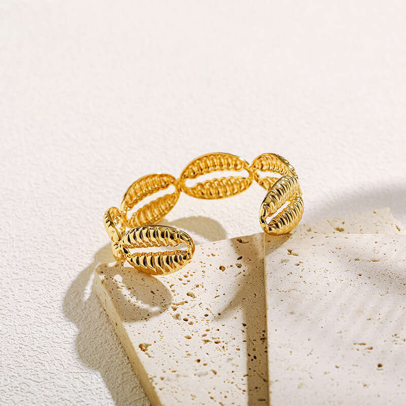 DH collections Vintage - style 18K Gold - plated Copper Bracelet with Shell Design. This bracelet in a geometric shape offers a retro and laid - back 