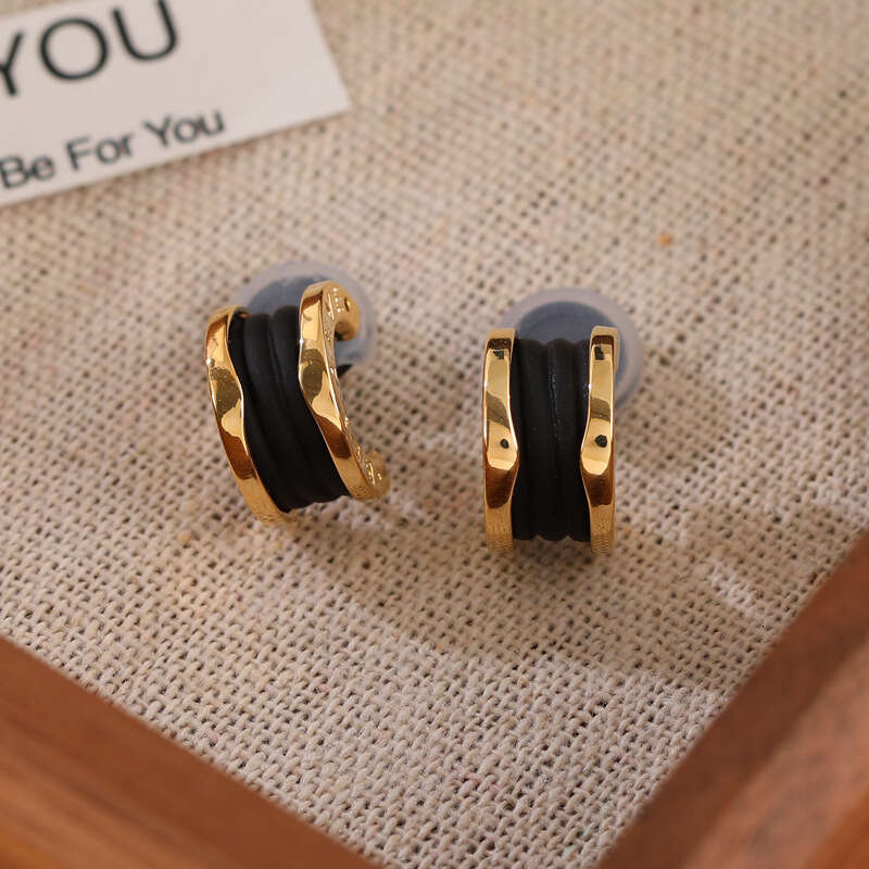 DH collections New Arrival! Women's Stylish Black Tweed - inspired Ear Clips & Earrings. Exude a touch of luxury with this trendy design.