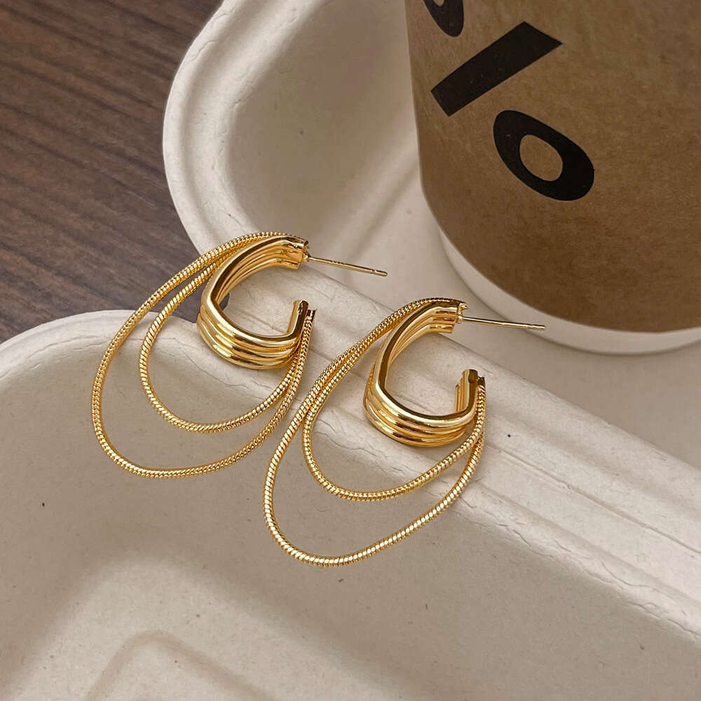 DH collections Geometric Irregular Multi - layer Snake Chain Tassel Earrings. These copper - plated real - gold earrings exude a niche