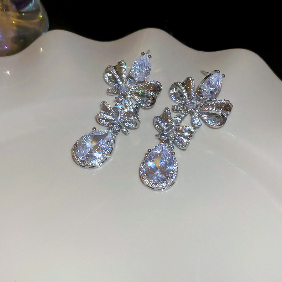 Silver Tone Bow & Teardrop Crystal Dangle Earrings With Dense Sparkling Crystal Detailing Luxury Glamorous Style Party & Evening Occasion Wear Gift Fo