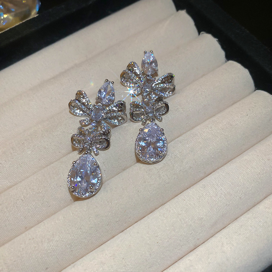 Silver Tone Bow & Teardrop Crystal Dangle Earrings With Dense Sparkling Crystal Detailing Luxury Glamorous Style Party & Evening Occasion Wear Gift Fo