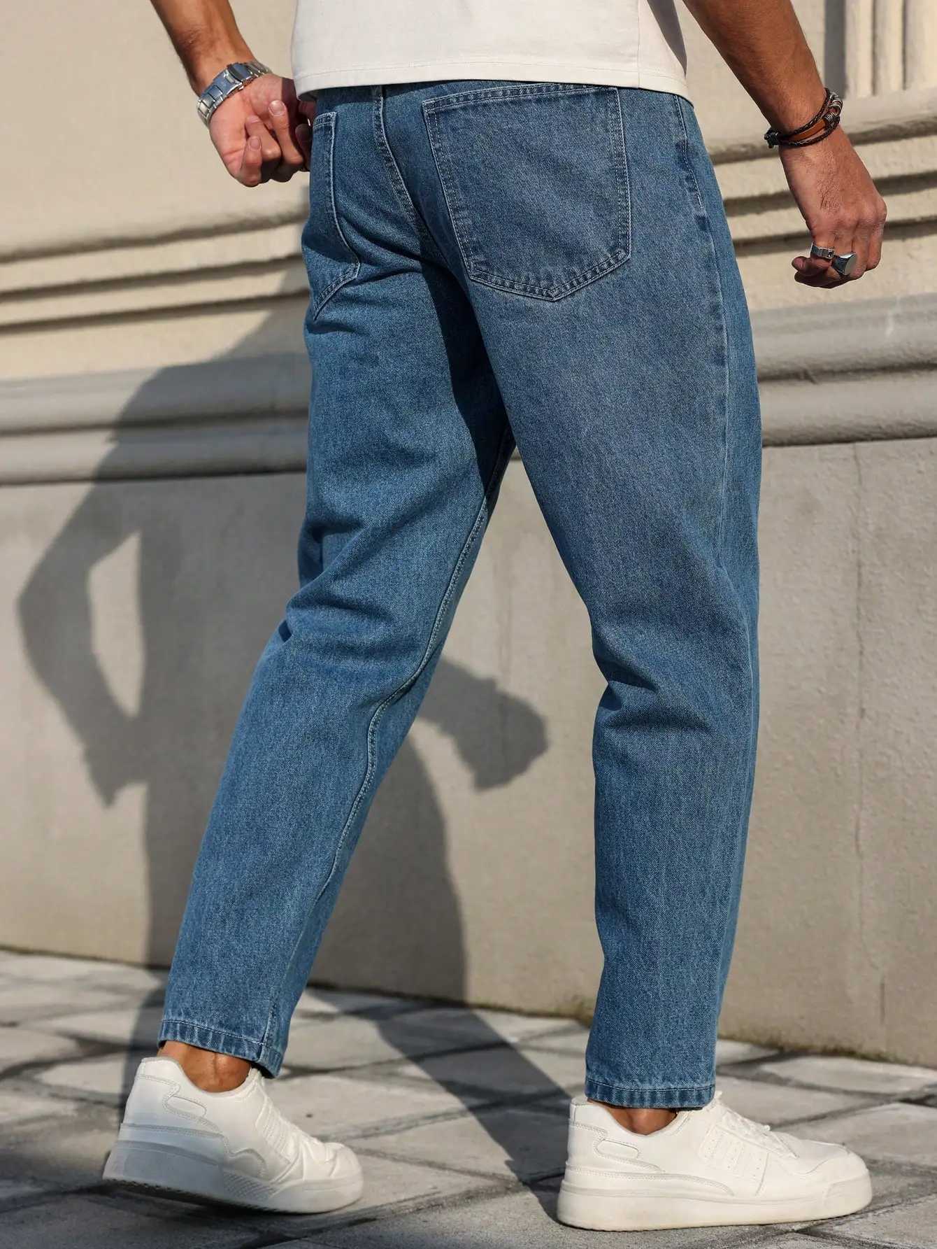 Mens jeans are made of classic blue denim fabric with a loose fit making them an indispensable versatile item in the wardrobe W250905
