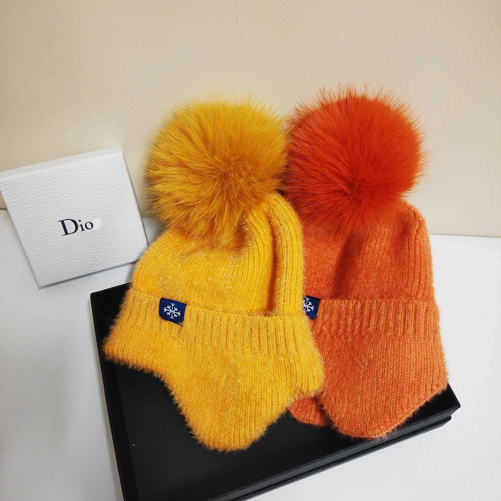 Hot selling couple ear protection hat can color scheme fashionable artificial large wool ball knitted hat Christmas skiingXJ250910