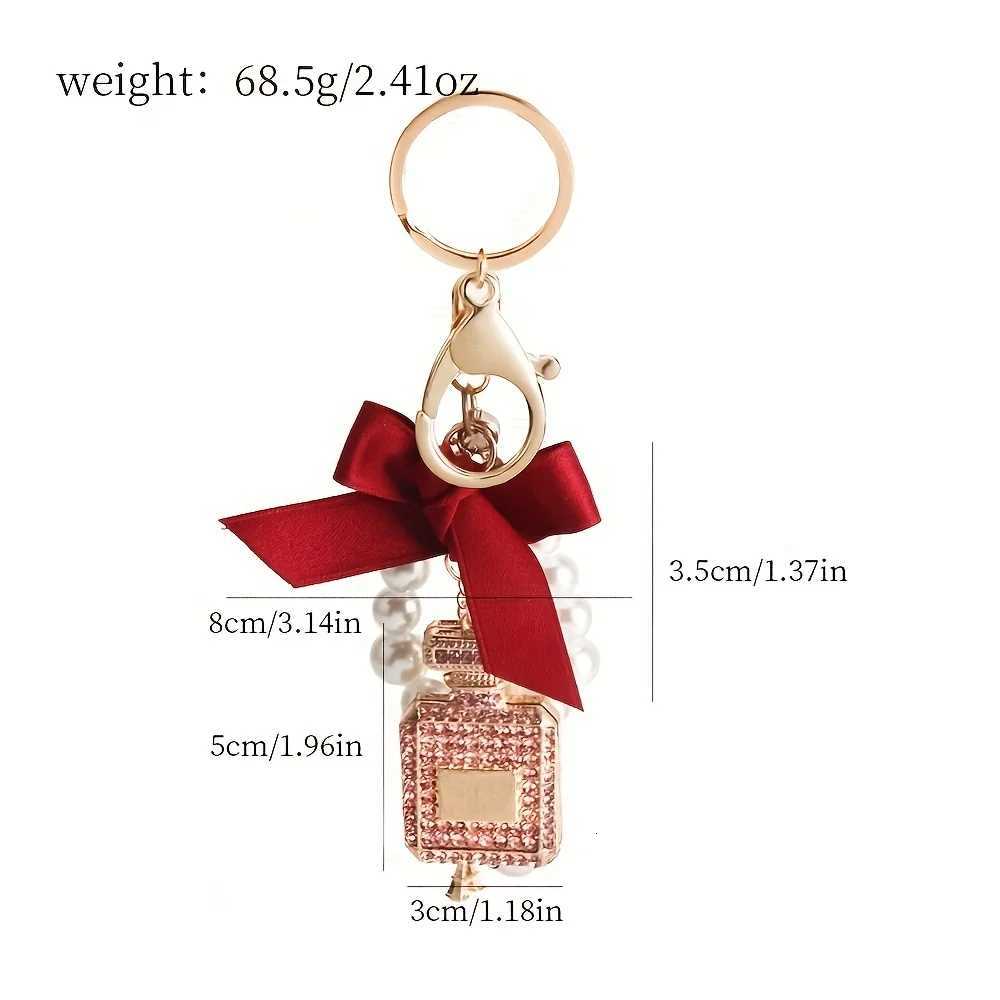 Alloy diamond inlaid bow shaped perfume bottle key chain creative pearl chain bag pendant exquisite key chain 1 S250911 ADWF