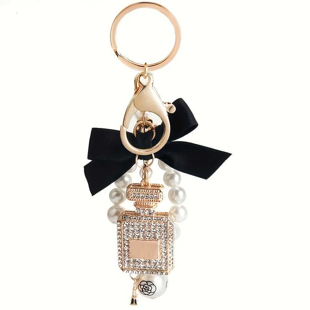 Alloy diamond inlaid bow shaped perfume bottle key chain creative pearl chain bag pendant exquisite key chain 1 S250911 ADWF