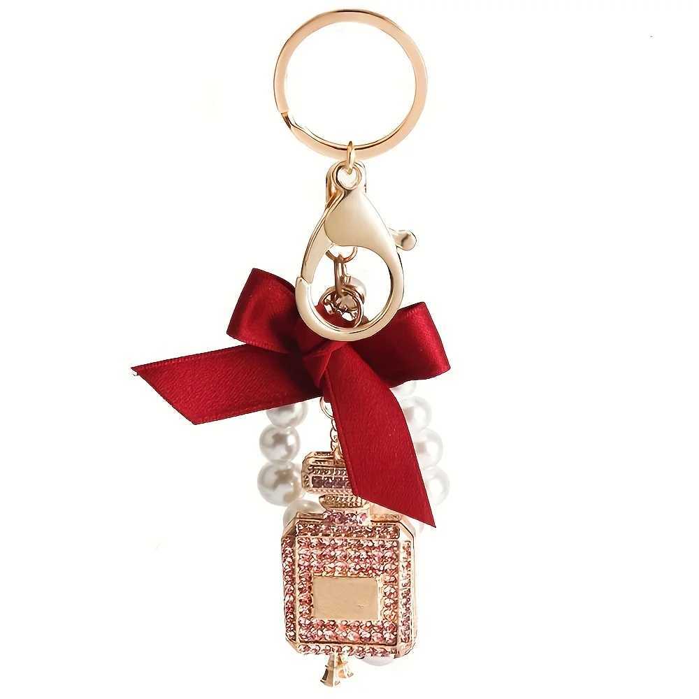 Alloy diamond inlaid bow shaped perfume bottle key chain creative pearl chain bag pendant exquisite key chain 1 S250911 ADWF