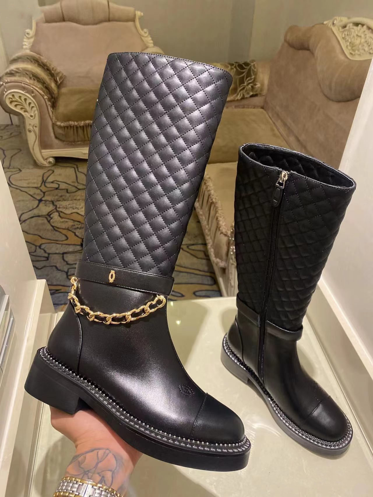 The luxurious ladies knee-high shoes designed by a French designer feature a unique chain design These womens long boots are of high quality both short long styles chan