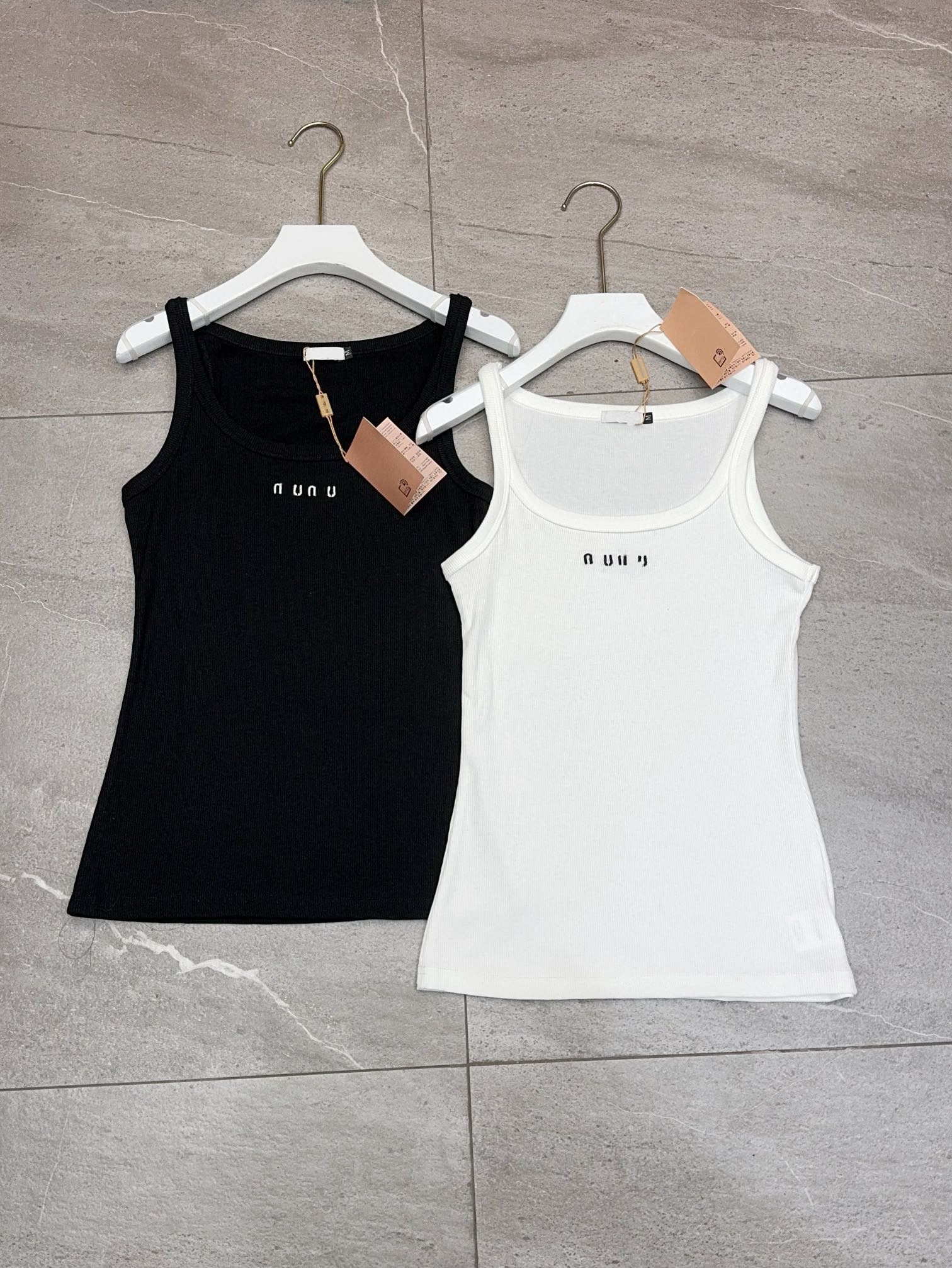 Designer brand M*'s new knitted ribbed vest with a front logo, available in black and white.