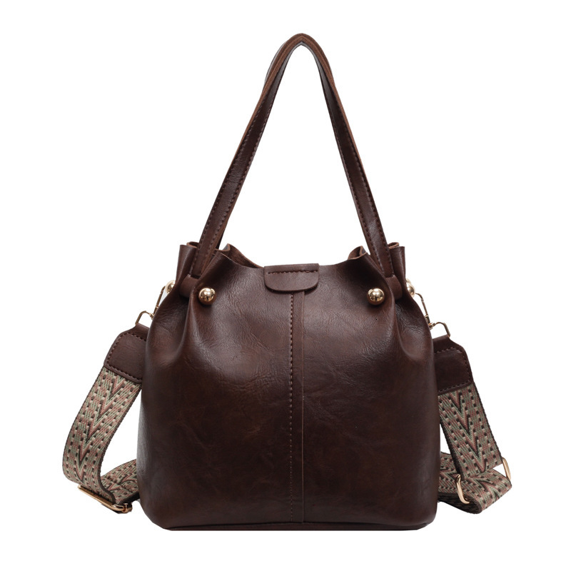 New autumn retro fashion simple texture bucket bag shoulder width design women s shoulder bag commuting bag autumn new designer bag women s crossbody 