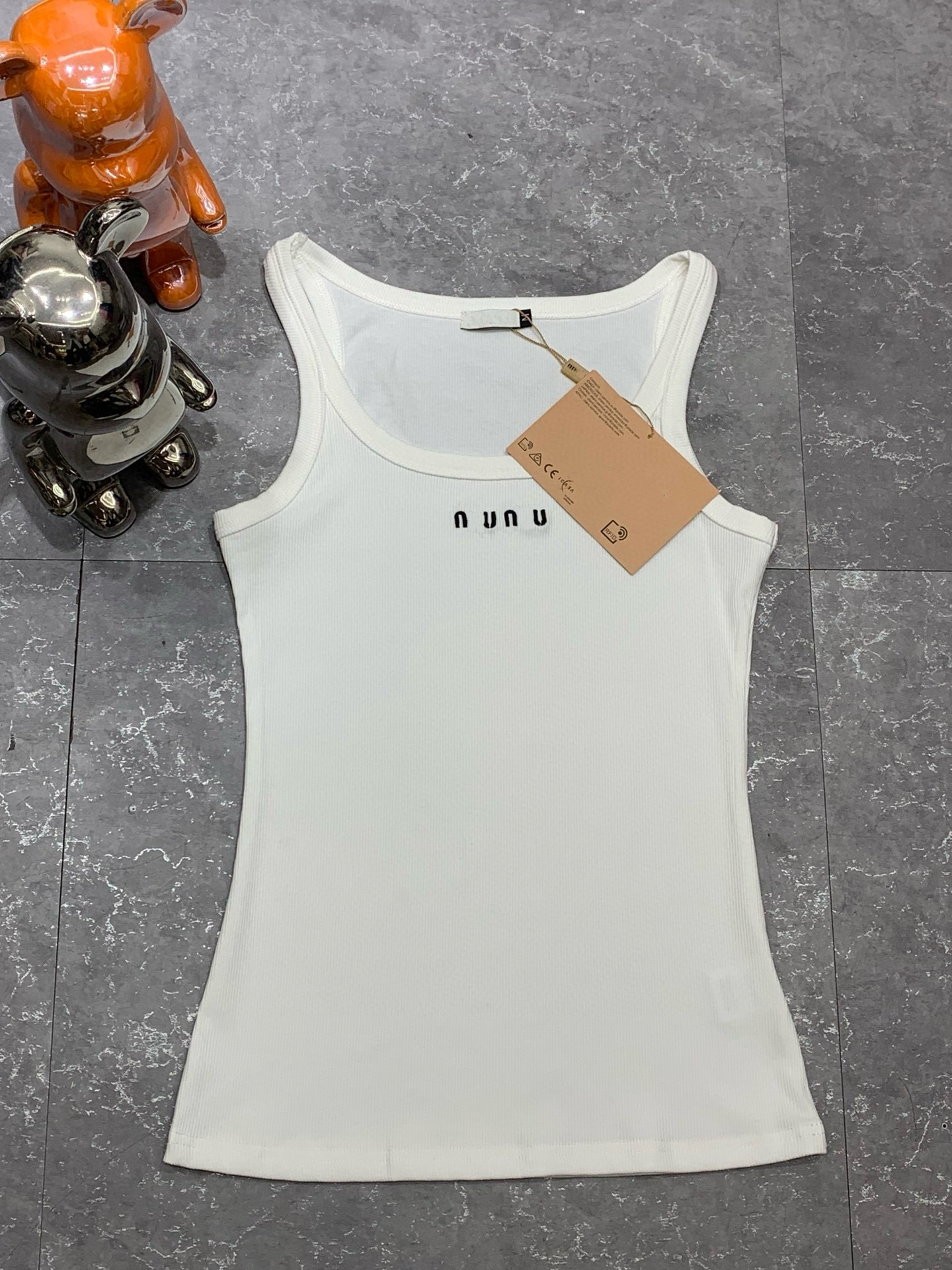 Designer brand M*'s new knitted ribbed vest with a front logo, available in black and white.