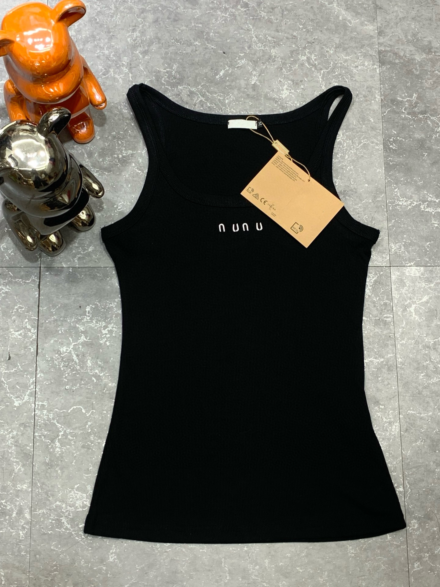 Designer brand M*'s new knitted ribbed vest with a front logo, available in black and white.