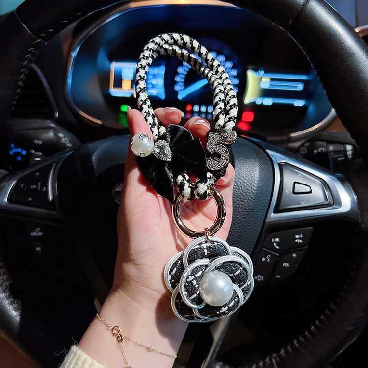 Fashion Exquisite Fashion Creative Weaving Small Fragrant Style Black and White Hand Rope Pearl Camellia Keychain Bag Pendant3 D250925