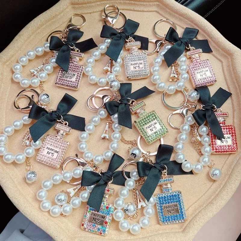 Fashion Exquisite Key Chain Alloy Diamond Inlaid Bow Shaped Perfume Bottle Key Chain Creative Pearl Chain Bag Pendant Car Keychain D250925