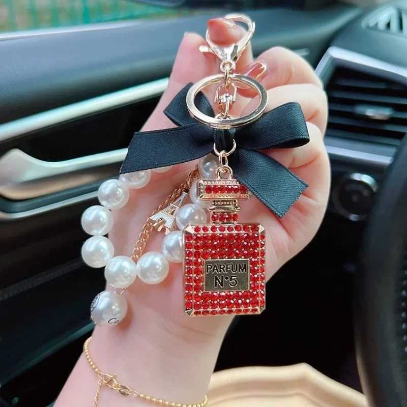 Fashion Exquisite Key Chain Alloy Diamond Inlaid Bow Shaped Perfume Bottle Key Chain Creative Pearl Chain Bag Pendant Car Keychain D250925