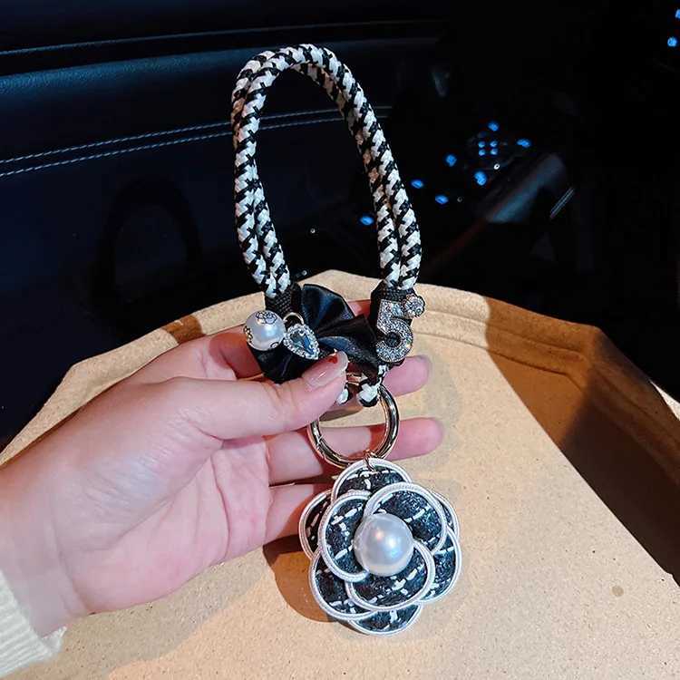 Fashion Exquisite Fashion Creative Weaving Small Fragrant Style Black and White Hand Rope Pearl Camellia Keychain Bag Pendant3 D250925