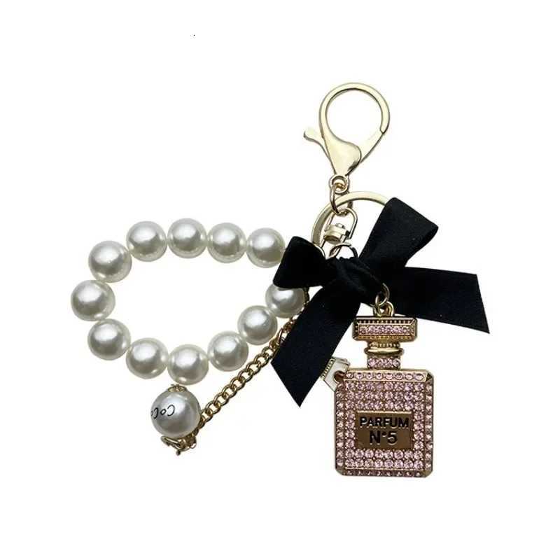 Fashion Exquisite Key Chain Alloy Diamond Inlaid Bow Shaped Perfume Bottle Key Chain Creative Pearl Chain Bag Pendant Car Keychain D250925