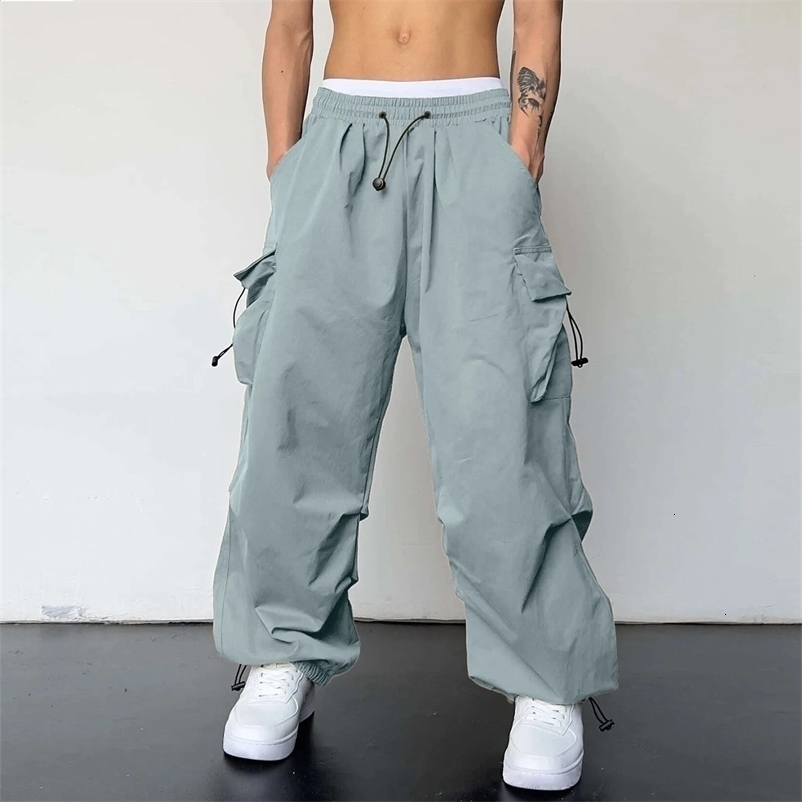 Streetwear mens cargo pants multi woven pockets foot ropes hip-hop bags mens solid pull rod umbrella pants mens clothing 240924