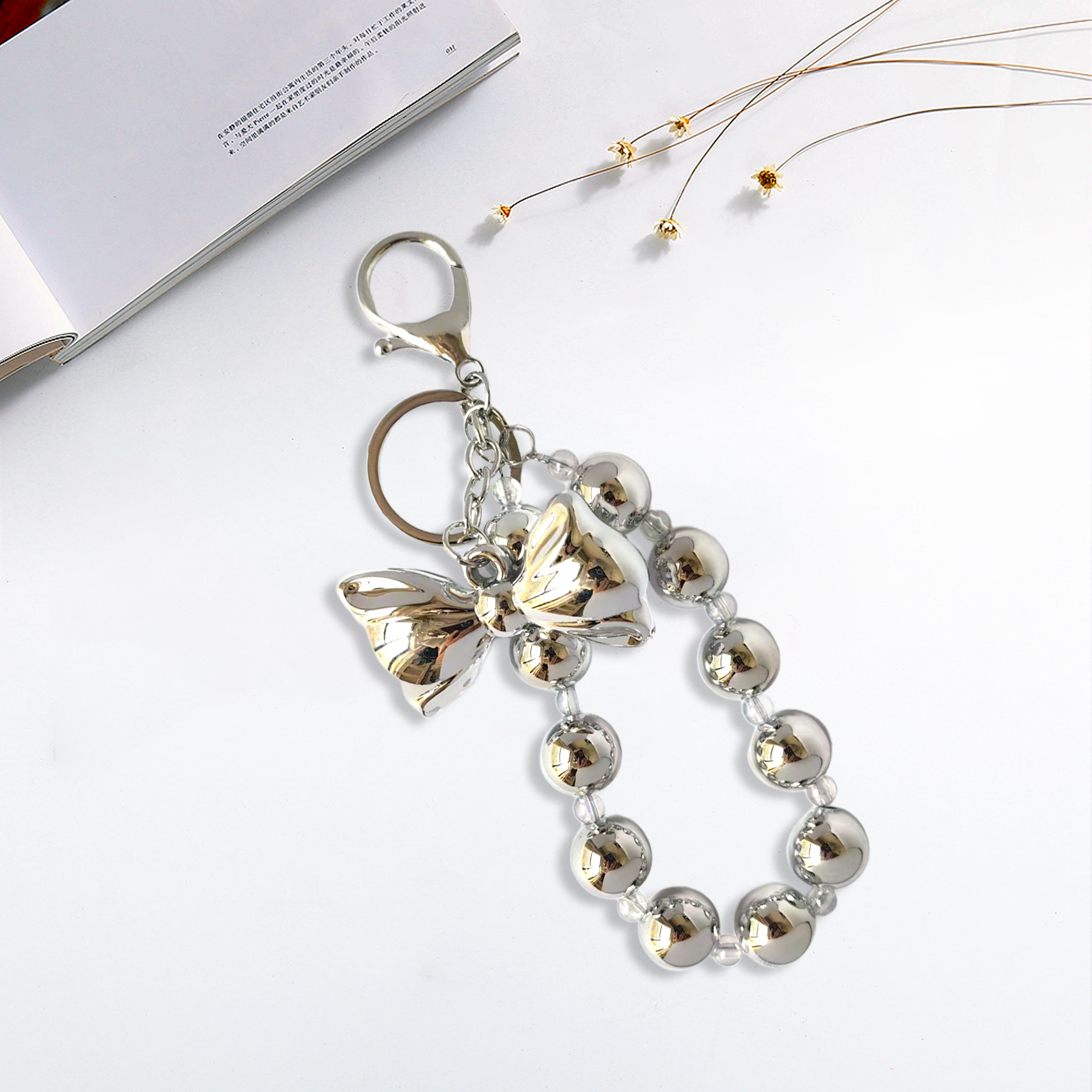Fashionable metallic pearl bow phone charm, personalized and creatively designed