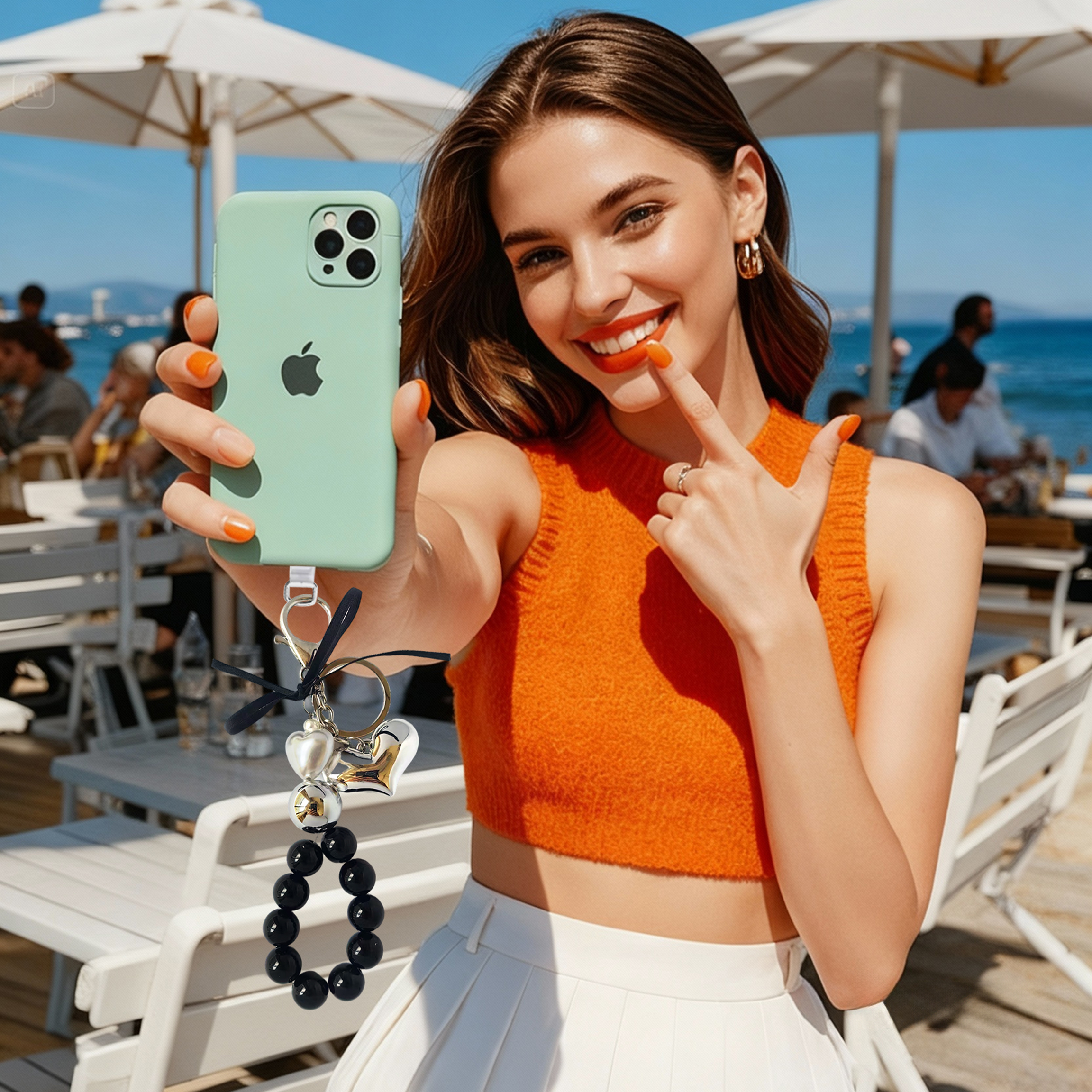 Fashion-forward phone charm, metal heart design, metallic pearls, black pearl strand, trendy accessory, anti-loss feature, easy to carry