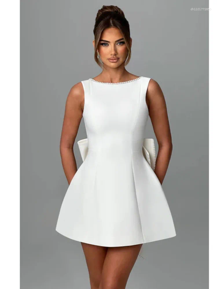 Elegant Backless Mini Dress: White Party Dress with Pearl Detail, Bow Accent & Corset Waist for Summer Beach or Wedding C260312