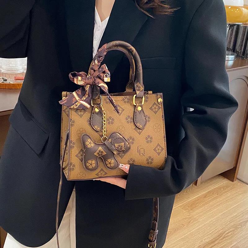 The new free shipping designer bag is a new brown khaki printed small handbag for women, a multi-functional and fashionable single-shoulder crossbody 