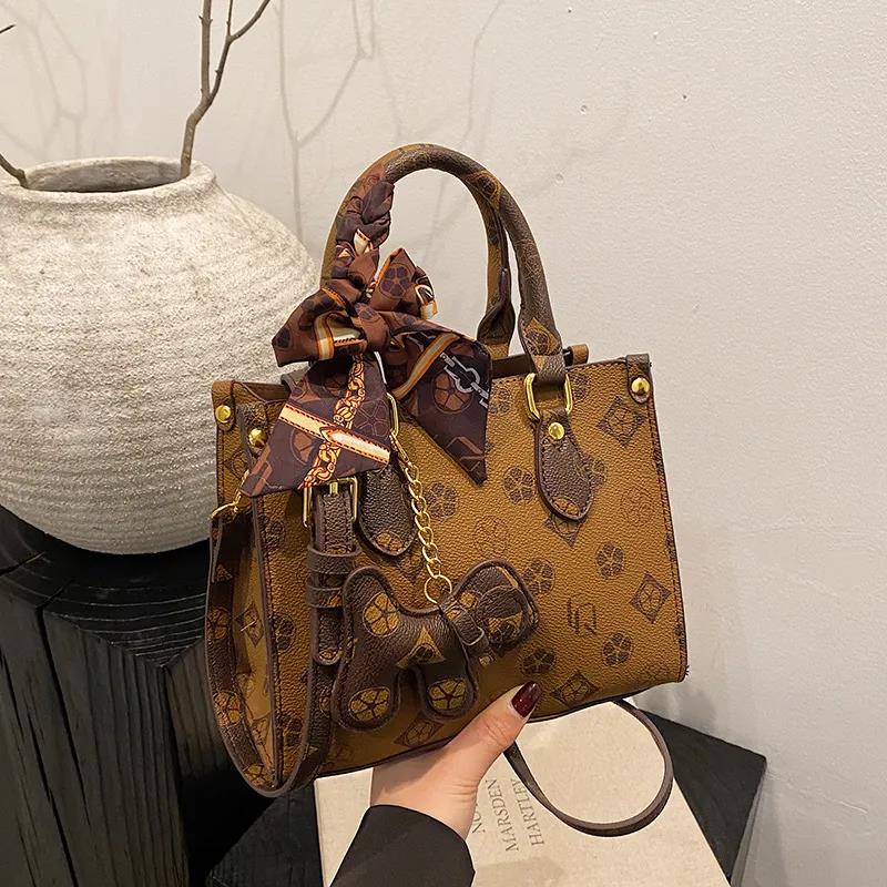 The new free shipping designer bag is a new brown khaki printed small handbag for women, a multi-functional and fashionable single-shoulder crossbody 