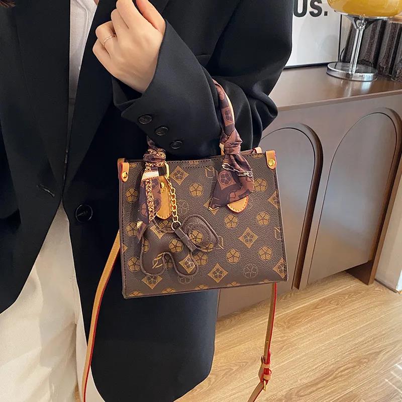 The new free shipping designer bag is a new brown khaki printed small handbag for women, a multi-functional and fashionable single-shoulder crossbody 