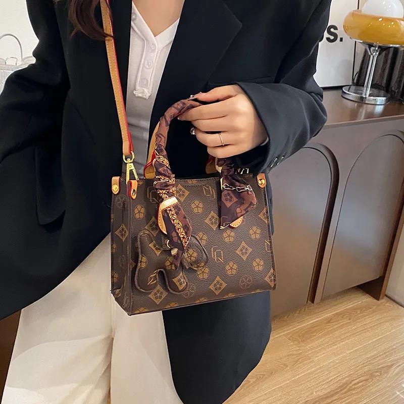 The new free shipping designer bag is a new brown khaki printed small handbag for women, a multi-functional and fashionable single-shoulder crossbody 