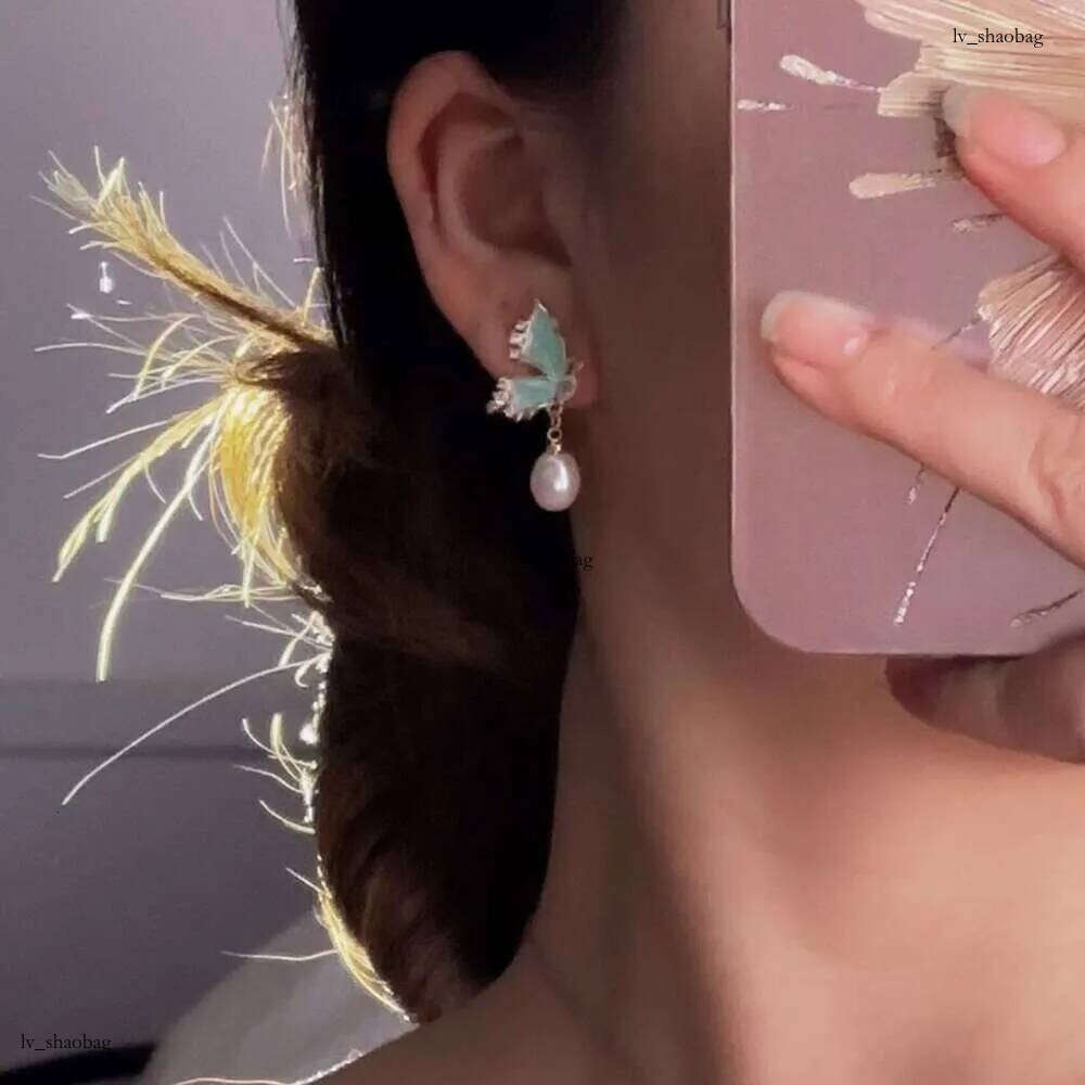 DHcollections Dan Tao S Sier Needle French Style Glazed Freshwater Rice-shaped Pearl Long Tassel Earrings for Women