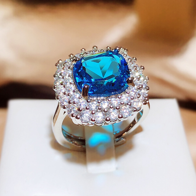 Silver Tone Square Blue Gem Ring With Round Sparkling Stone Halo Accents Glam Evening And Special Occasion Accessory Gift For Her Luxurious And Dazzli