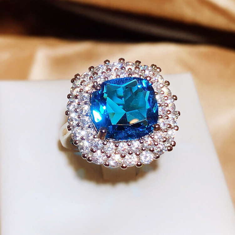 Silver Tone Square Blue Gem Ring With Round Sparkling Stone Halo Accents Glam Evening And Special Occasion Accessory Gift For Her Luxurious And Dazzli