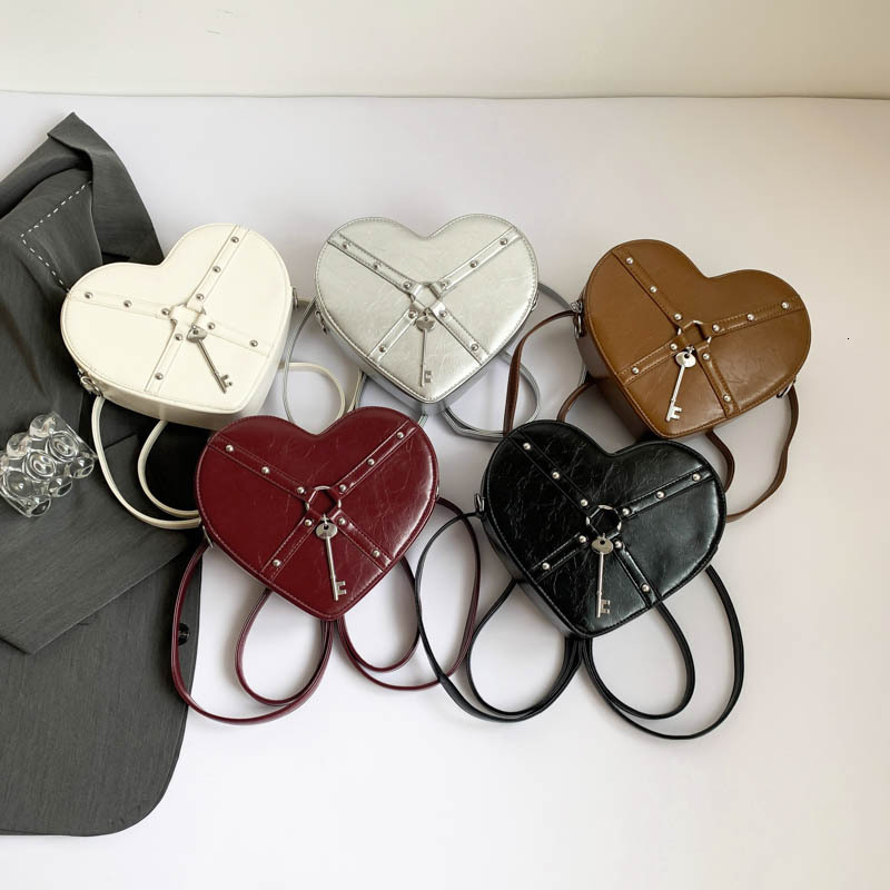 Free shipping designer Unique Hot Girl Heart Bag Women New Trend Rivet Motorcycle Style Shoulder Bag Crossbody Bag Personality Backpack