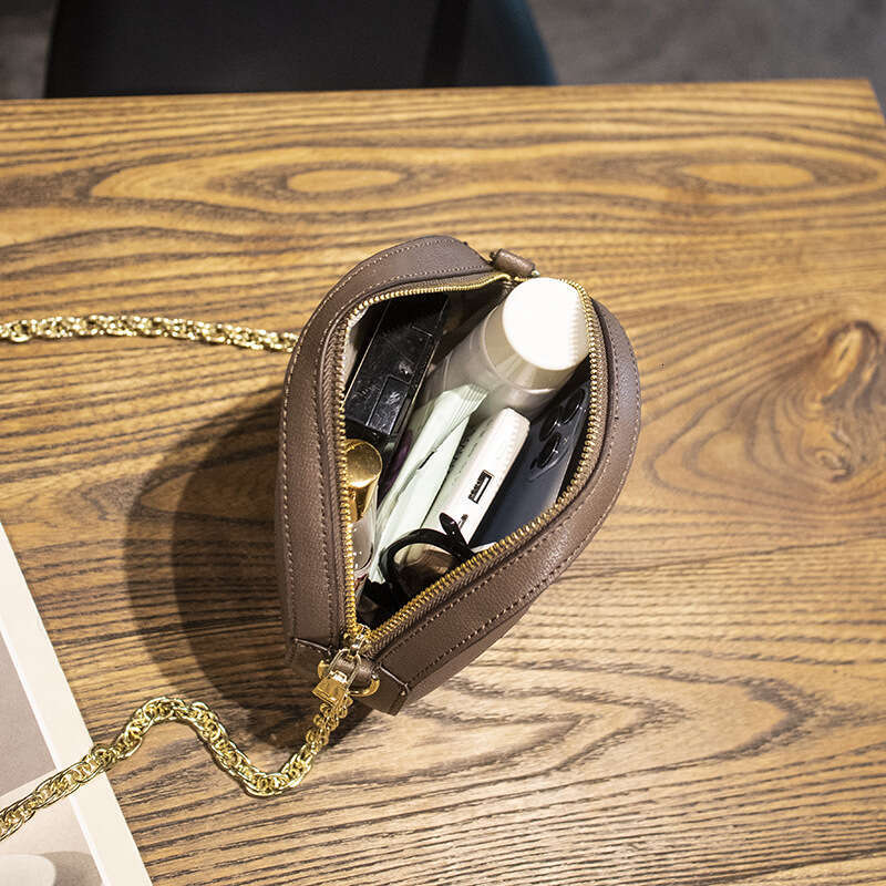 Stylish Compact Lady Bag Featuring Swappable Chain Accents Suitable for Multiple Outings