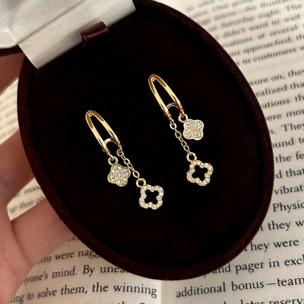 2025 Hot Luxury jewelry designer earrings with geometric hollow zirconia 4-leaf flower tassel earrings copper plated gold high-end light luxury earrin
