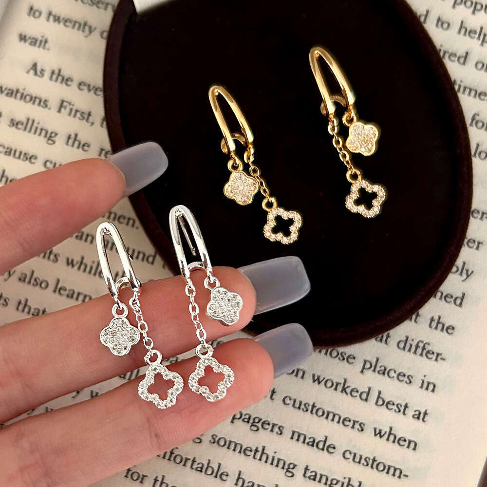 2025 Hot Luxury jewelry designer earrings with geometric hollow zirconia 4-leaf flower tassel earrings copper plated gold high-end light luxury earrin