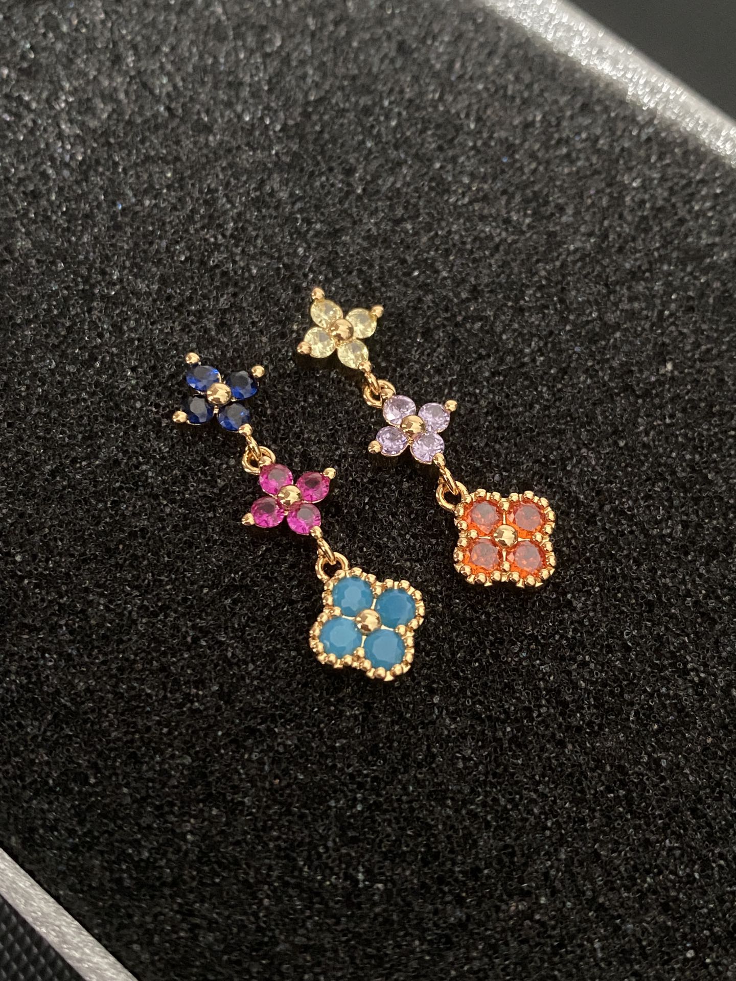 Multicolored gemstone flower - shaped earrings, possibly light luxury accessories from a fashion brand.