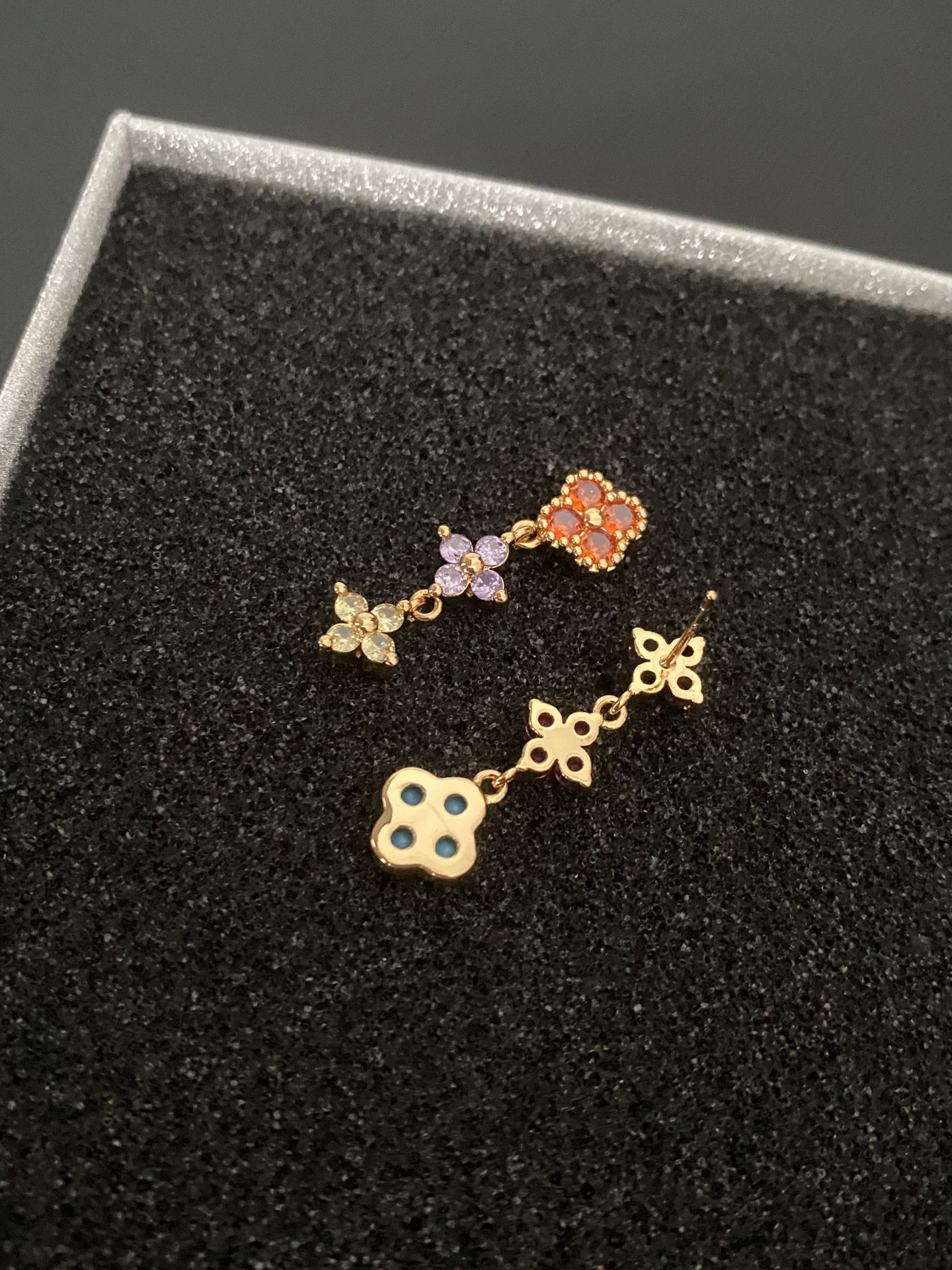 Multicolored gemstone flower - shaped earrings, possibly light luxury accessories from a fashion brand.