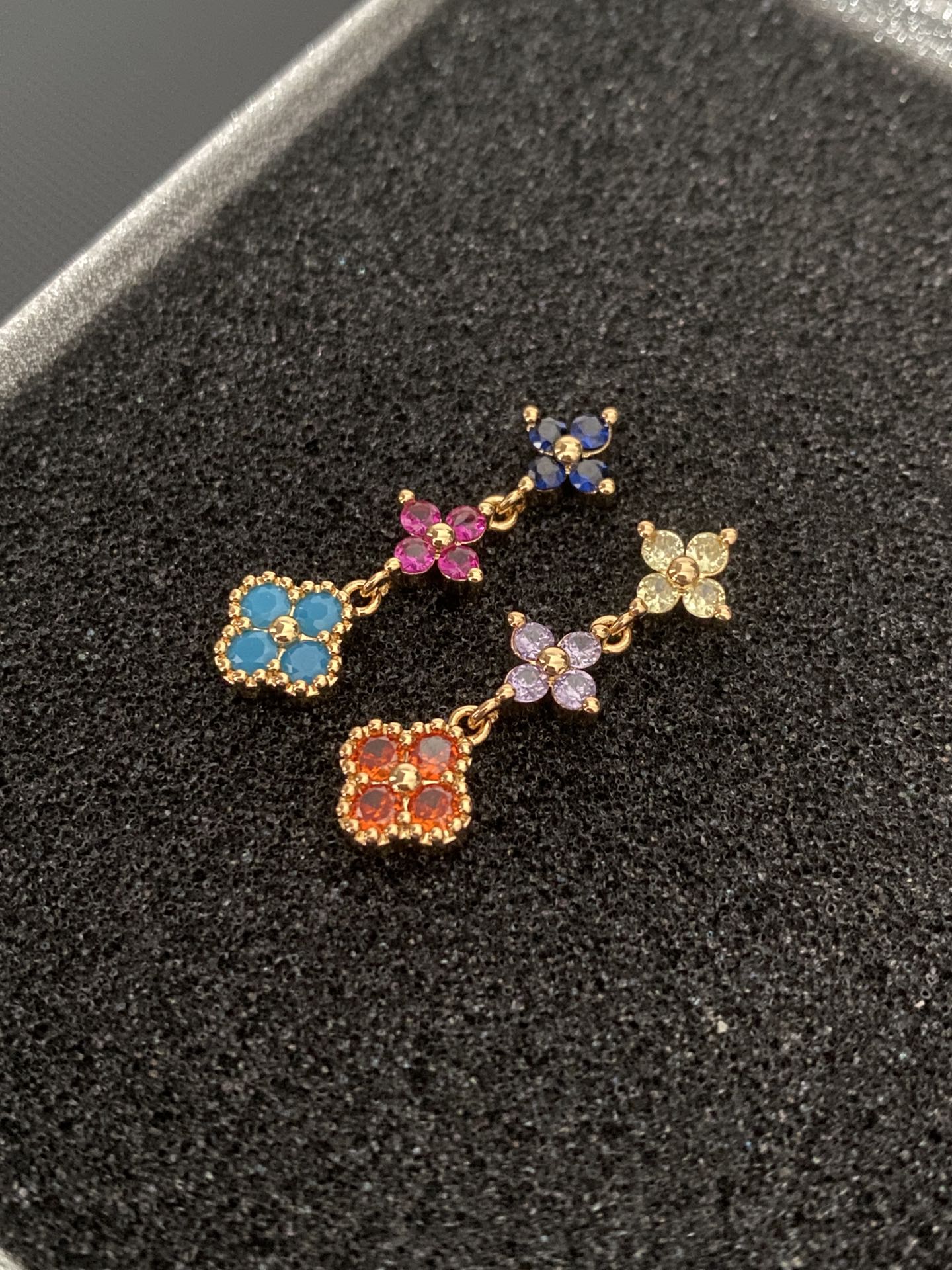 Multicolored gemstone flower - shaped earrings, possibly light luxury accessories from a fashion brand.