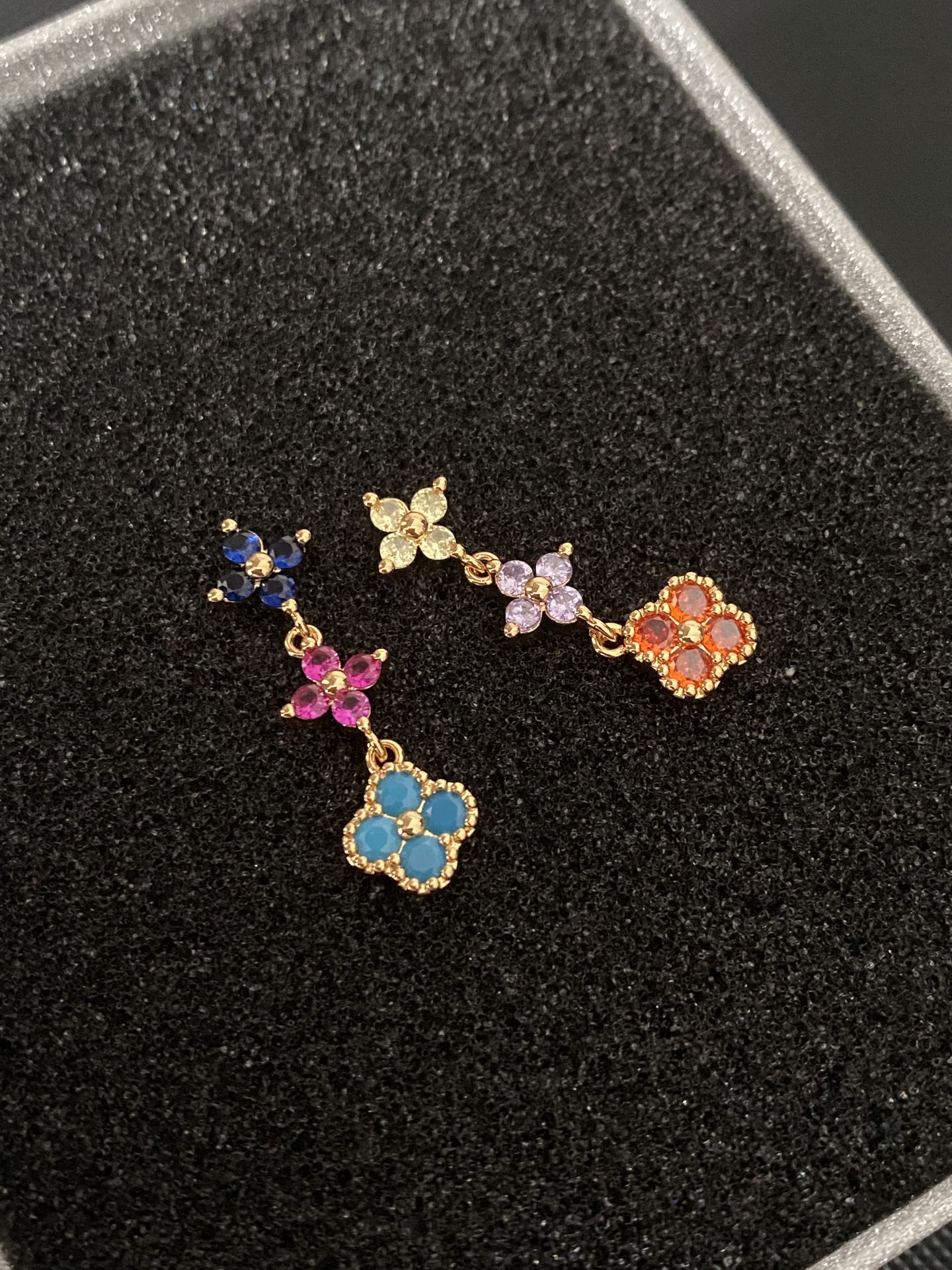 Multicolored gemstone flower - shaped earrings, possibly light luxury accessories from a fashion brand.