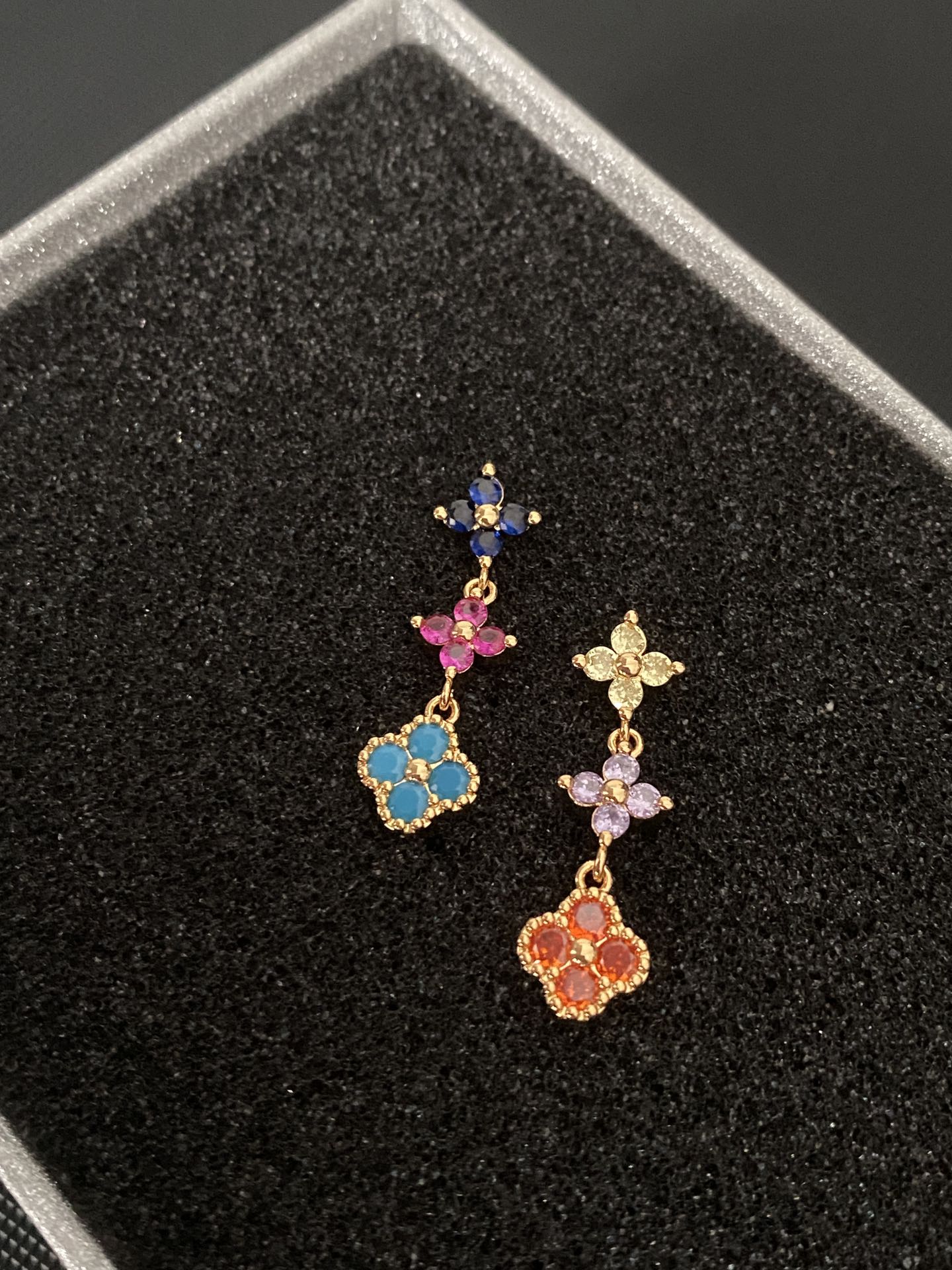 Multicolored gemstone flower - shaped earrings, possibly light luxury accessories from a fashion brand.