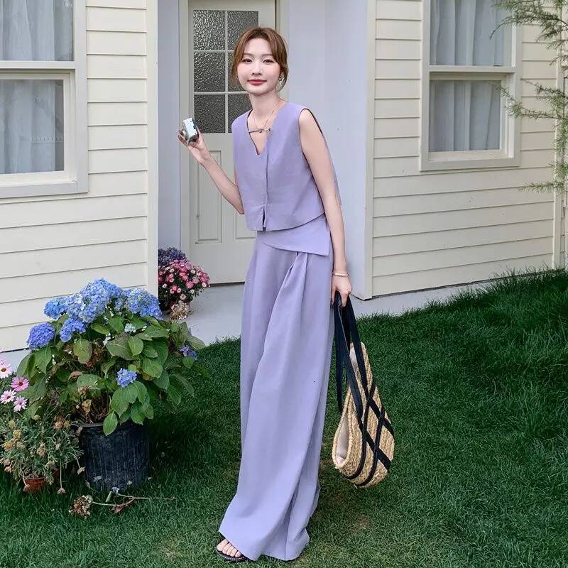 2025 summer fashion Korean hollow solid design color short sleeved top for women, featuring long pants and a two-piece designer top