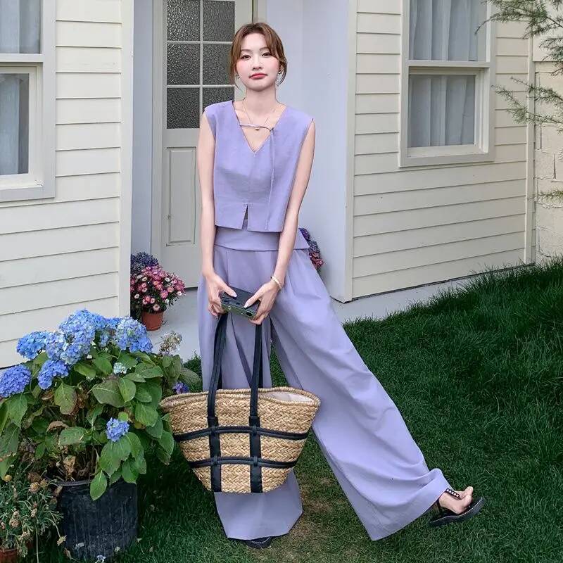 2025 summer fashion Korean hollow solid design color short sleeved top for women, featuring long pants and a two-piece designer top